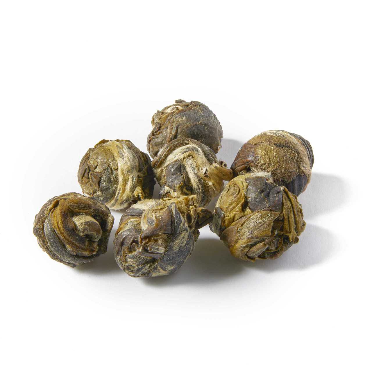 A macro pile of Jasmine Dragon Pearls Loose Leaf tea