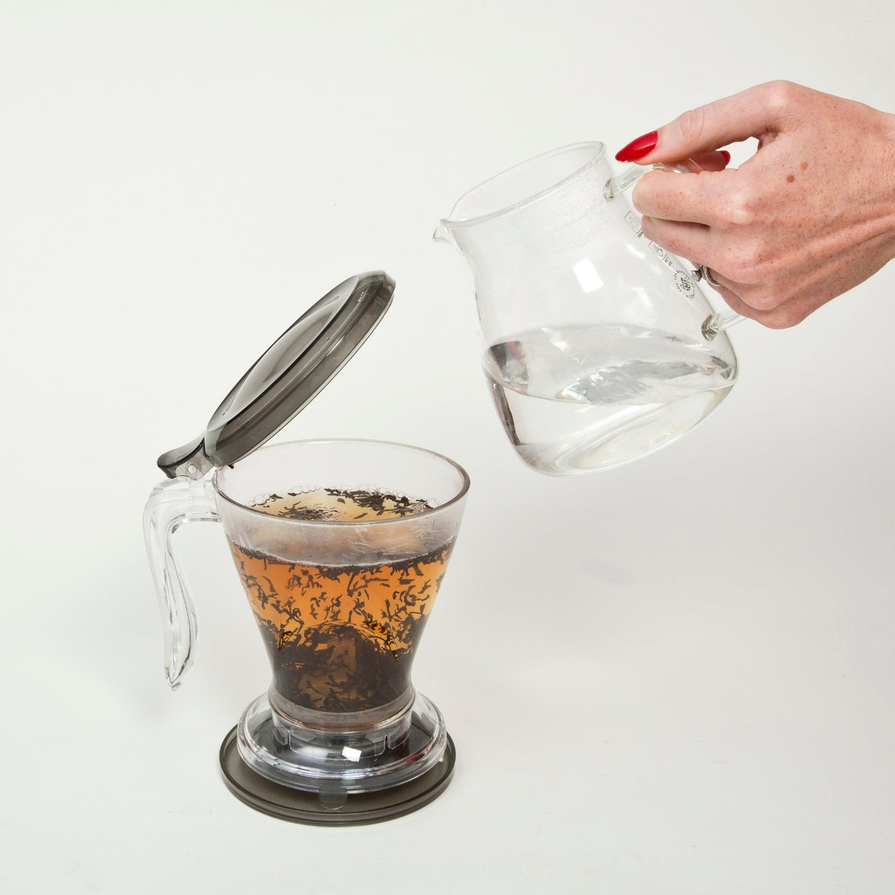 A person pouring hot water in the Magic Gravity Infuser For Tea & Coffee